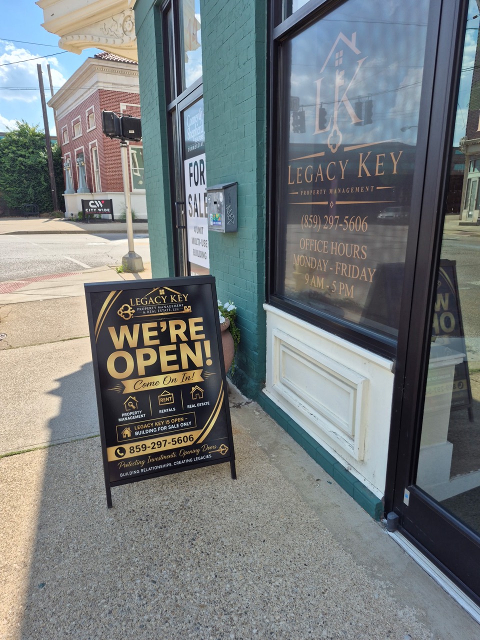 Legacy Key Property Management storefront and open sign on W. Pike Street in Covington