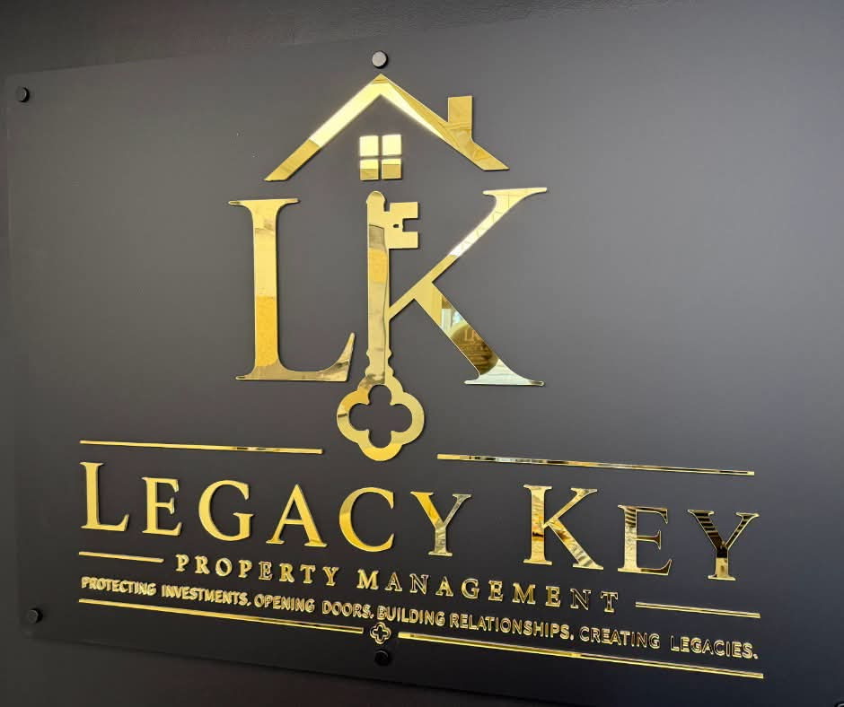 Gold Legacy Key Property Management wall sign inside the Covington office